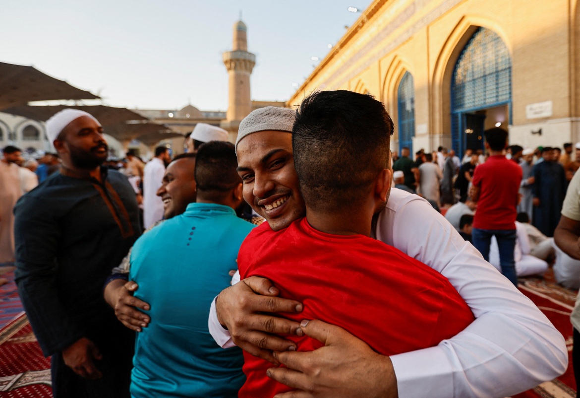 Muslim worshippers hug each other after prayers on the first day of the Eid al-Adha festival, at the shrine of Muslim leader Sheikh Abdul Qadir al-Gilani, in Baghdad, Iraq.
