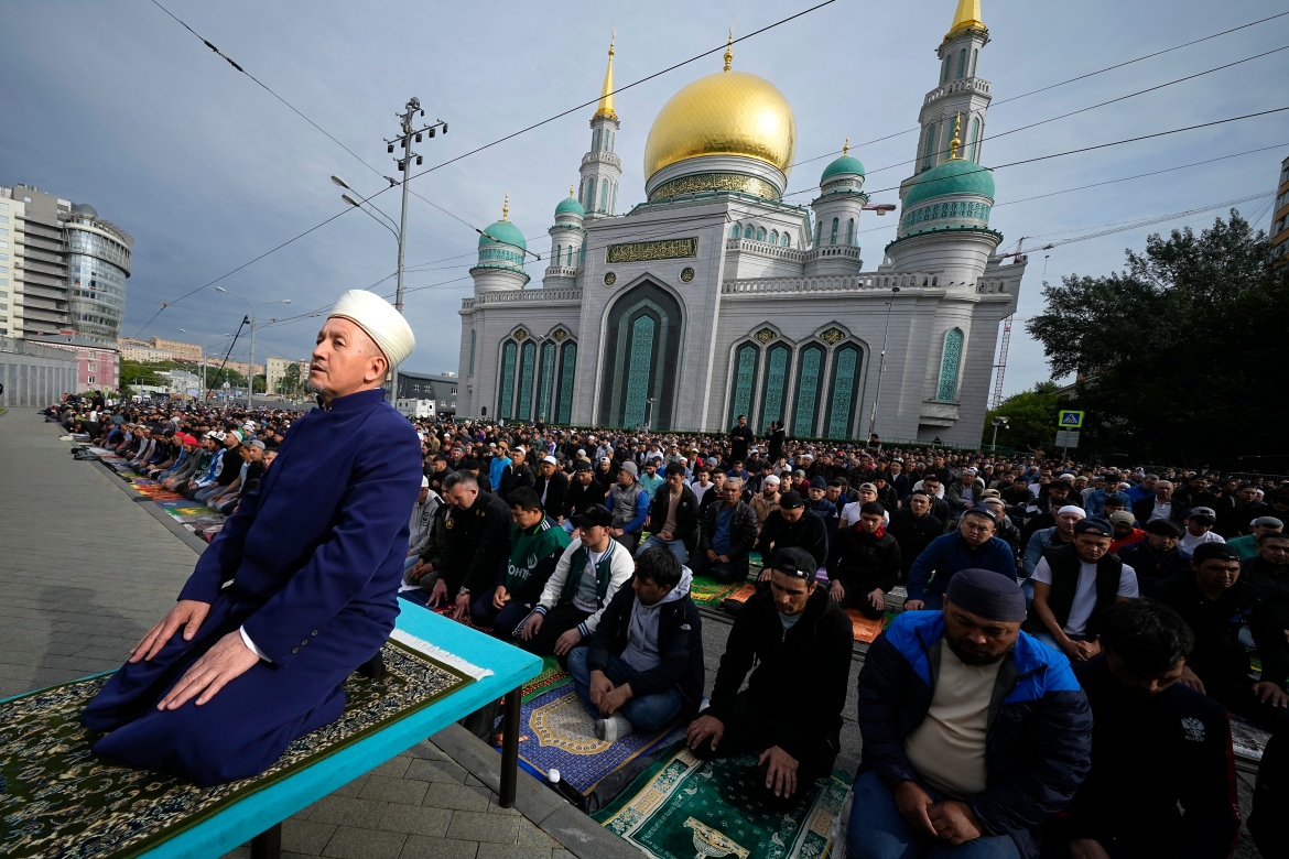 Muslims pray outside the Moscow Cathedral Mosque during celebrations in Moscow, Russia.