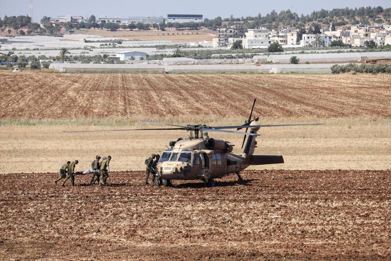Israeli military carry a wounded person on a stretcher to a helicopter during a raid on Jenin refugee camp near Salem checkpoint, the entrance from Israel to Jenin in the Israeli-occupied West Bank, July 3.