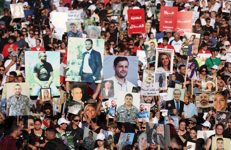 People and families of the victims of the Beirut port blast on August 4, 2020, carry their pictures during a march as Lebanon marks the three-year anniversary of the explosion in Beirut, Lebanon, August 4, 2023.
