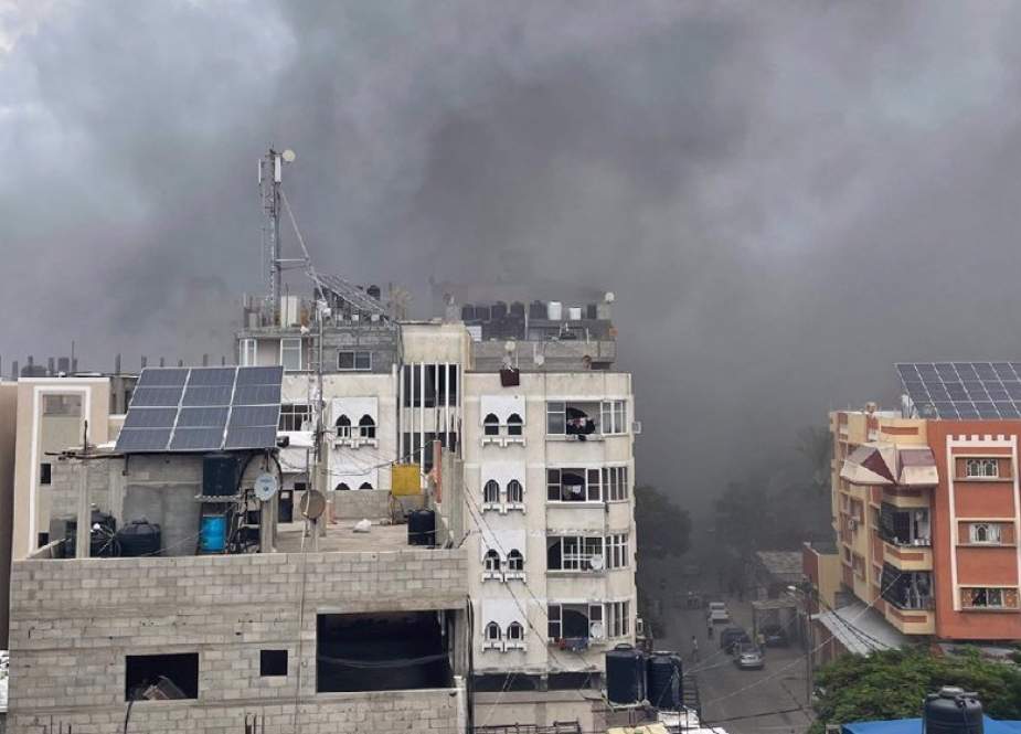 Smoke rises following an Israeli air strike against a residential building at al-Shati refugee camp located in the northern Gaza Strip.jpg