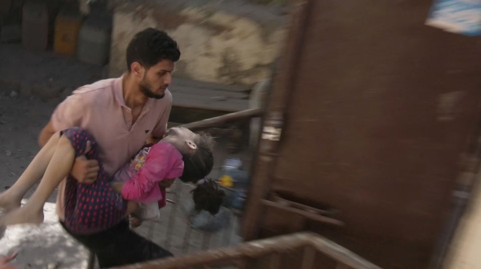 A man carries an injured child after an Israeli blast in Gaza City, October 18.