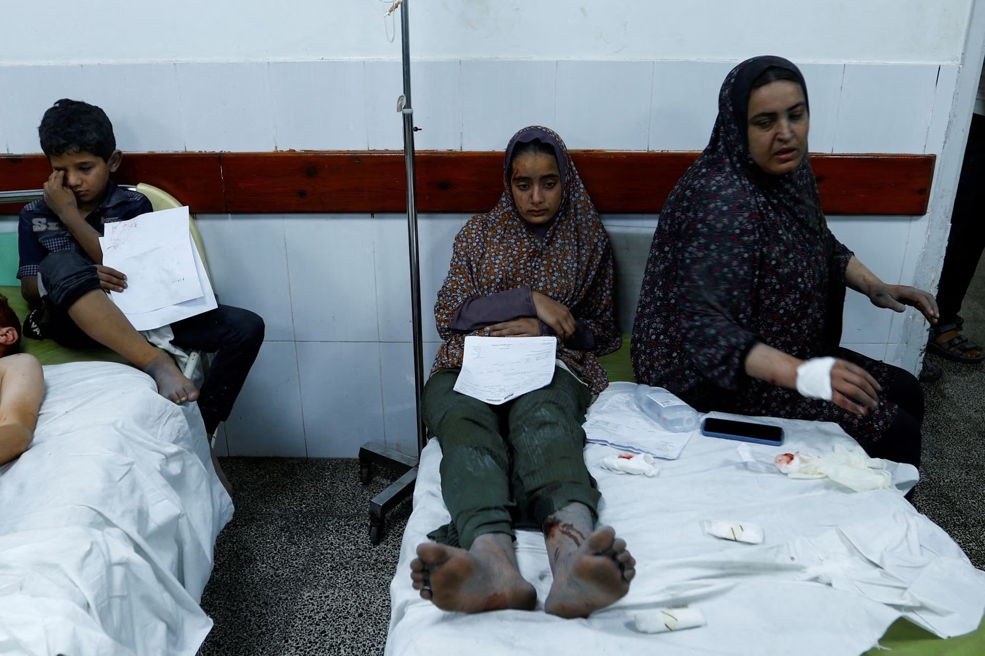Palestinian women and a boy, wounded in Israeli strikes, lie at a hospital in the southern Gaza strip, October 17.