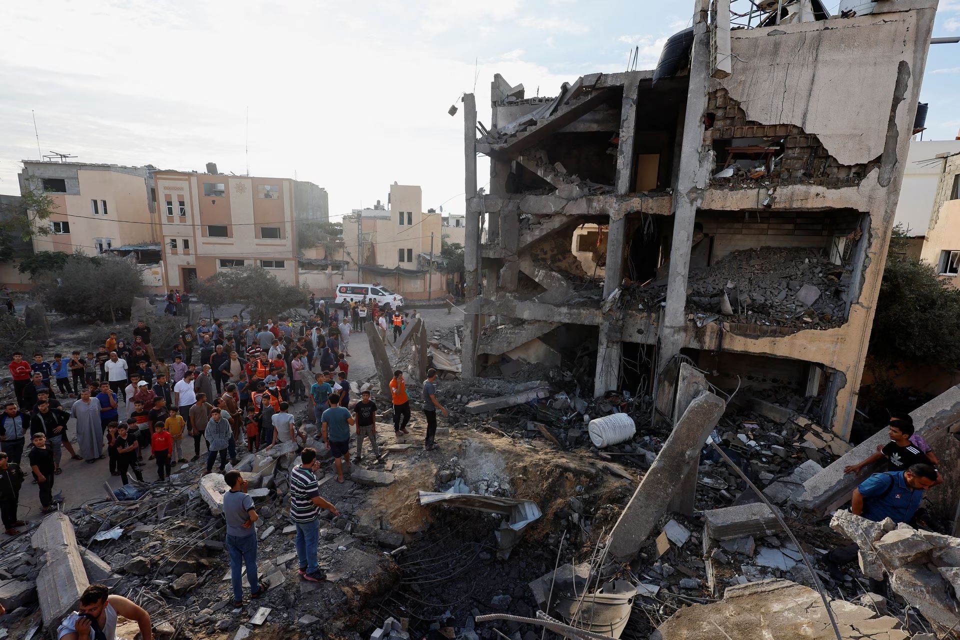 Palestinians search for casualties under the rubble of a building destroyed by Israeli strikes in Khan Younis in the southern Gaza Strip, October 17.