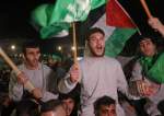 Palestinian prisoners cheer after being released in exchange for hostages freed by Hamas in Gaza