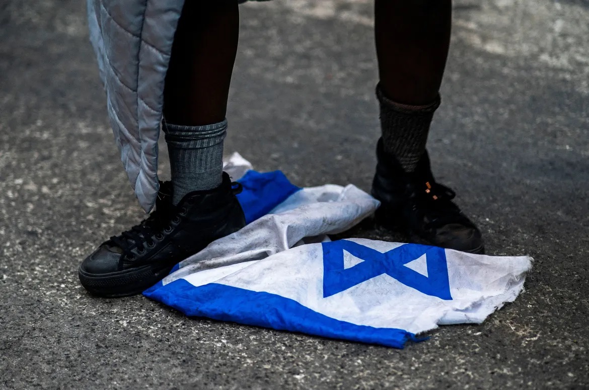 A protester steps on the Israeli flag during the march in New York.