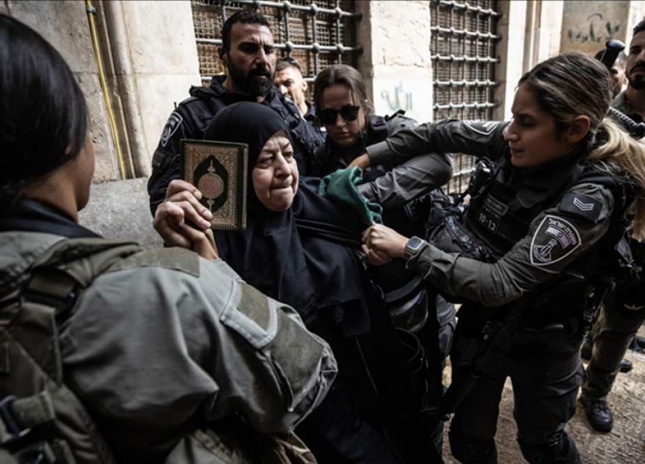 Israeli forces attacking a Palestinian woman worshiper near al-Aqsa Mosque compound in al-Quds.