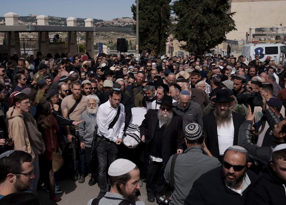 Israeli settlers walk in funeral