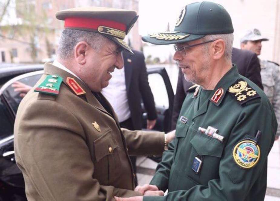 Chief of Staff of the Iranian Armed Forces Major General Mohammad Baqeri shakes hands with Syrian Defense Minister Ali Mahmoud Abbas in Tehran