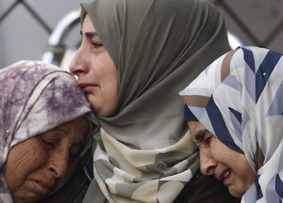 Palestinian women mourn realtives killed during an Israeli bombardment of Najjar Hospital in Rafah