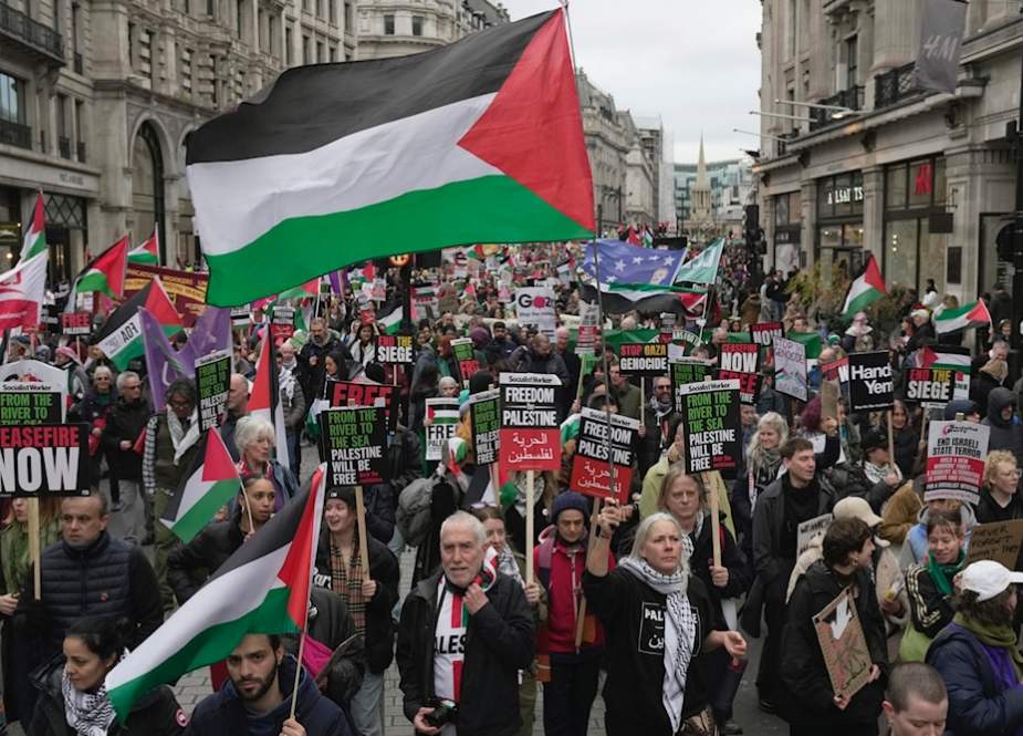 Pro-Palestine protesters hold banner, flags and placards in demonstration in London