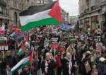 Pro-Palestine protesters hold banner, flags and placards in demonstration in London