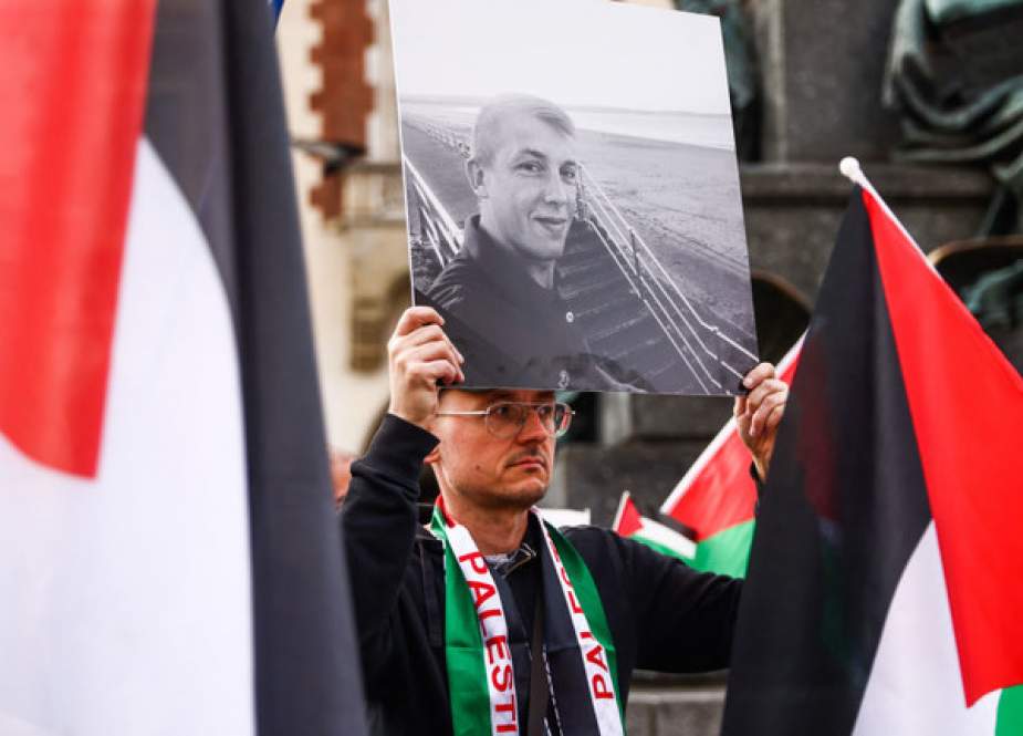 A demonstrator in Krakow, Poland, displays a photo of one of the aid workers killed in an Israeli drone attack