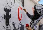 Displaced Palestinian artists paint an anti-Israel mural in Rafah, Gaza