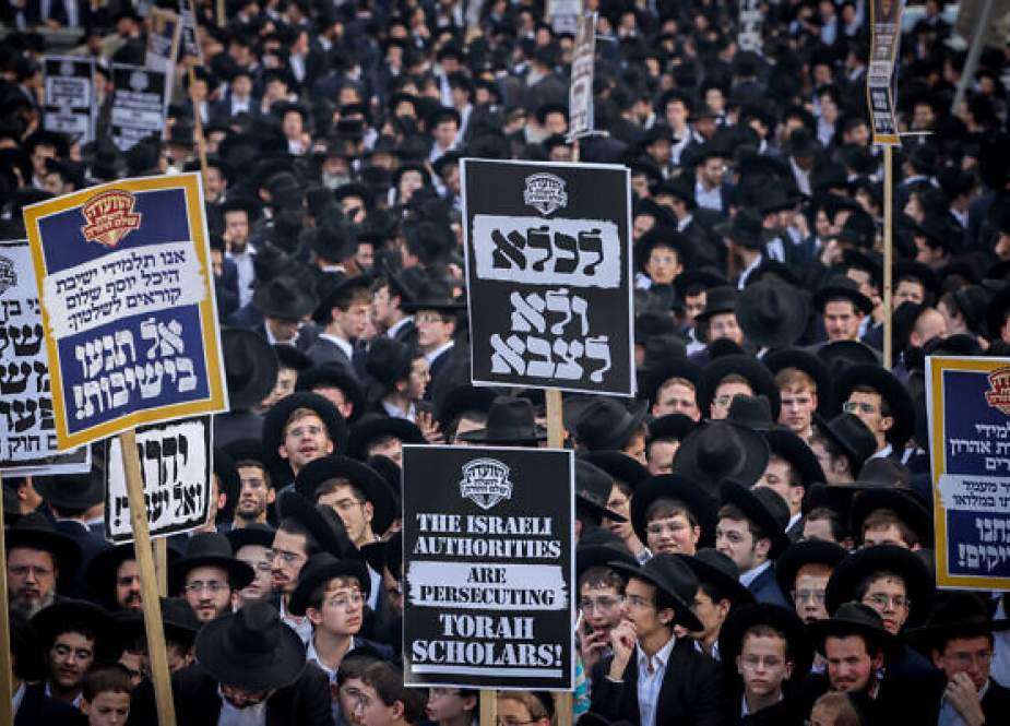 Ultra-Orthodox protesters demonstrate against the Israeli occupation army draft in Al-Quds