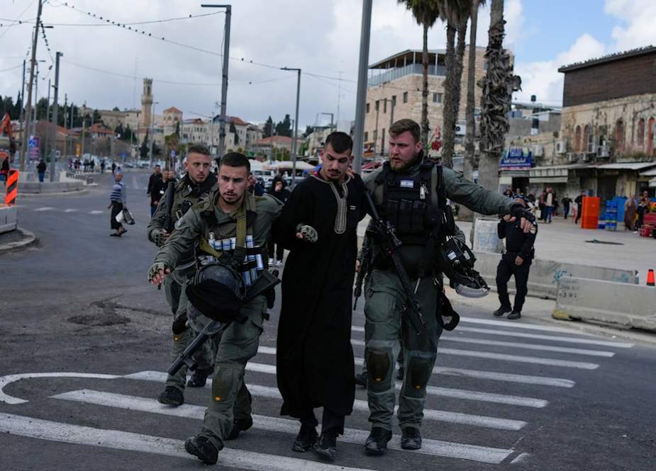 Israeli occupation forces detain a Palestinian man during the Muslim holy month of Ramadan just outside al-Quds