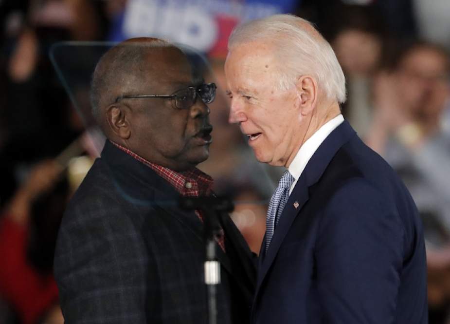 Joe Biden speaks to Rep. James Clyburn (D-S.C.) at a primary election night rally