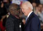 Joe Biden speaks to Rep. James Clyburn (D-S.C.) at a primary election night rally