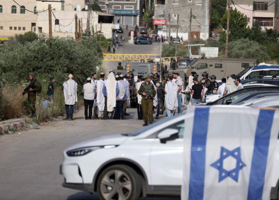 Jewish settlers block entry and exit roads to the town of Al-Lubban ash-Sharqiya near Nablus, West Bank