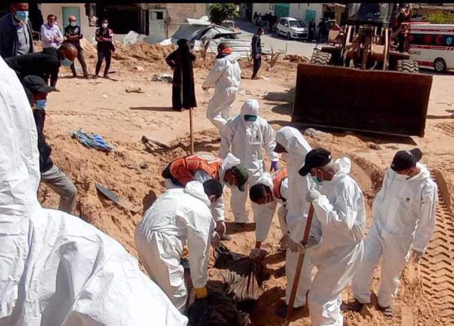 Palestinian civil defense teams unearth a mass grave at the Nasser hospital in Khan Yunis, in southern Gaza