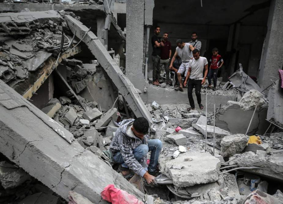 Palestinians checking the damage in a house that was destroyed by Israeli bombardment in Gaza