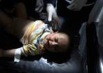 Palestinian medics treat a wounded child at the Kuwaiti Hospital, Rafah in the Israeli bombardment of the Gaza Strip