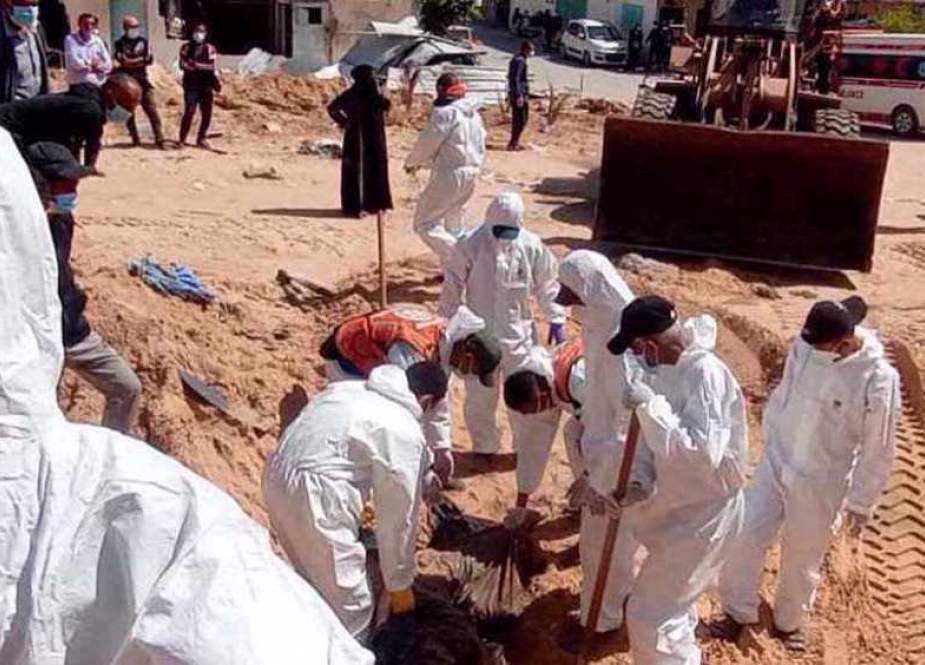 Palestinian civil defense teams unearth a mass grave at the Nasser Hospital in Khan Yunis, the southern Gaza Strip