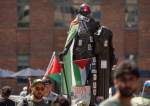Stickers and Palestinian flag cover a Geoge Wahington statue in George Washington Univ