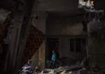 A Palestinian child looks at the damage to his family’s house after an Israeli strike in Rafah