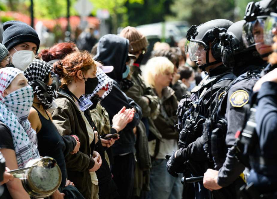 Police and pro-Palestine protesters stand-off in front of the barricaded Portland State University library