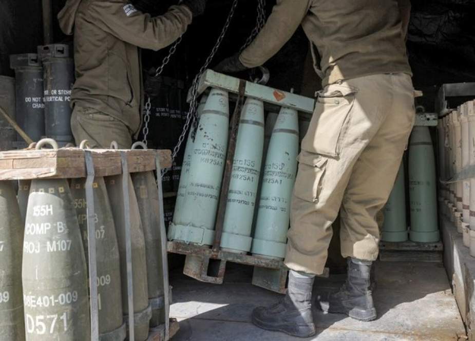 Israeli soldiers transport munitions off a vehicle at a position in the Israeli-annexed Golan Heights
