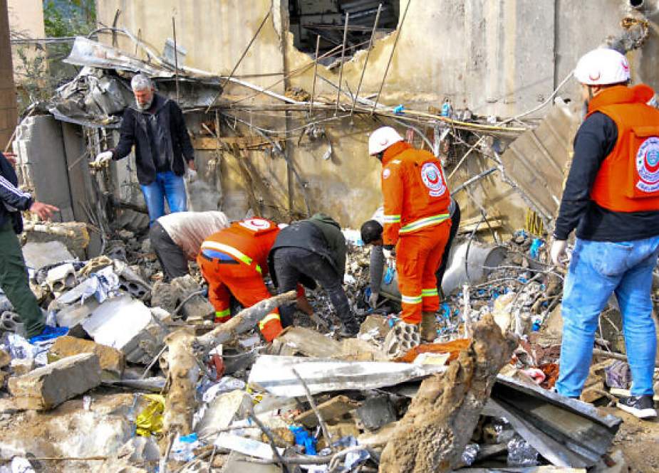 Aid workers inspect destruction at the site of Israeli strike on health center in the border town of Hibariyeh