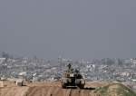 Israeli occupation forces overlook the Gaza Strip from a tank, southern occupied Palestine