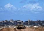 An Israeli tank overlooks the Gaza Strip, as seen from southern Israel