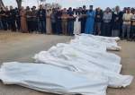 Mourners pray over the bodies of members of the Abu Taha family who were killed in an Israeli airstrike
