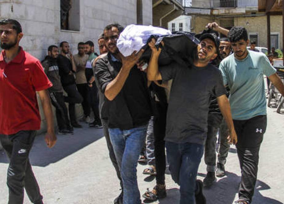 A body is brought to Al-Ahli Arab Hospital in Gaza City for burial following an Israeli attack
