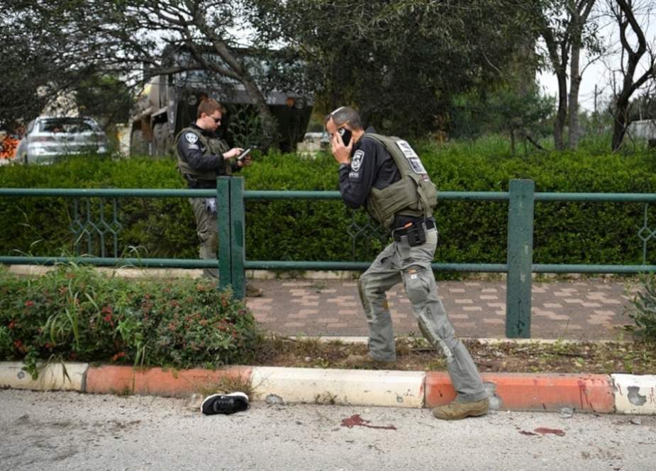 Israeli occupation forces examine the site hit by a rocket fired from Lebanon in Kiryat Shmona, northern occupied Palestine