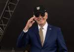 US President Joe Biden salutes as graduates celebrate after receiving diplomas at West Point, New York