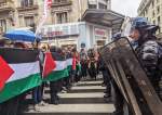 Protestors in Paris holding Palestinian flags and chanting slogans against the Israeli genocide in Gaza