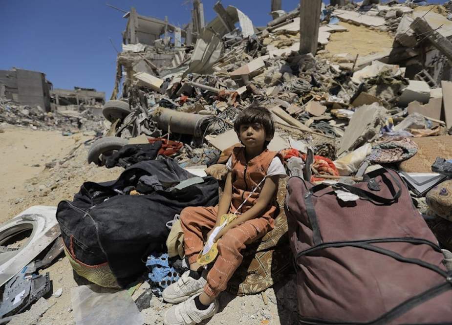 A Palestinian child sitting on the rubble of a residential building bombed by IOF in Gaza (UNRWA)A Palestinian child sitting on the rubble of a residential building bombed by IOF in Gaza (UNRWA)